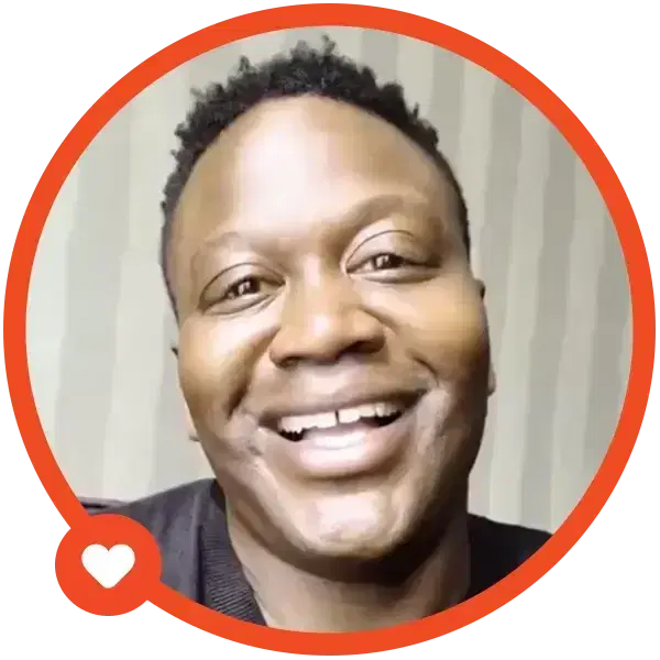 A person smiling inside an orange frame with a heart icon.