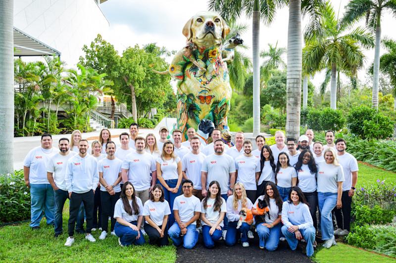 A group of spot employees posing with their pets